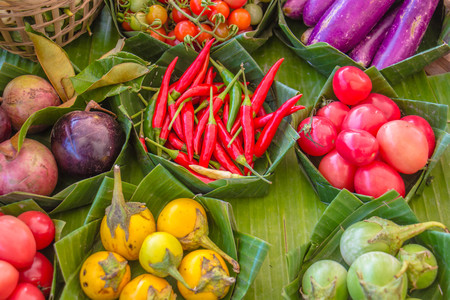 Fresh organic vegetables in baskets made of handmade bamboo.の写真素材