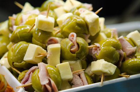 Tasty tapas with olives ham and cheeseの写真素材
