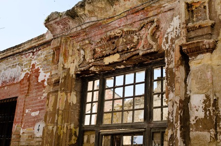 Old abandoned window detail of a window of a house in ruinsの写真素材