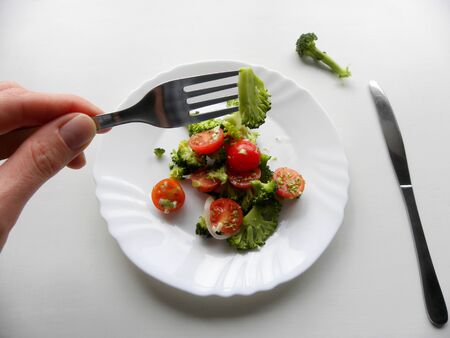broccoli on a fork. broccoli and cherry tomato saladの写真素材