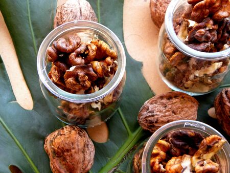 walnut in a jar on a green backgroundの写真素材
