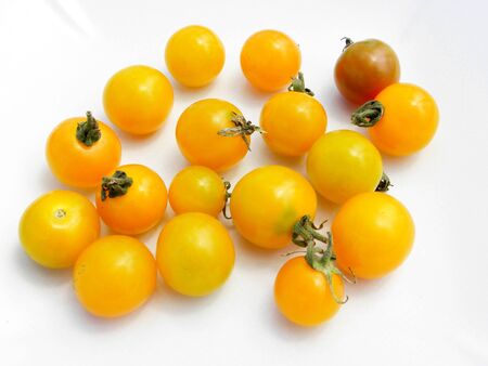 yellow cherry tomatoes isolated on white backgroundの写真素材