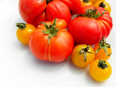 fresh red tomatoes on white background. yellow cherry tomatoesの写真素材