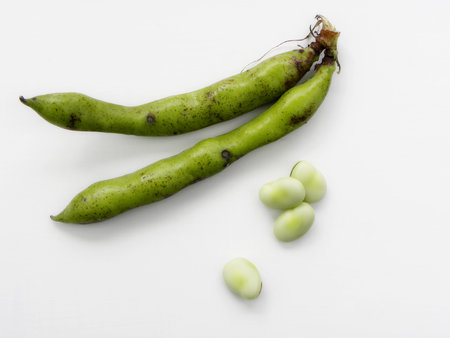 green beans in pods on a white background