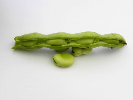 green beans in pods on a white backgroundの写真素材