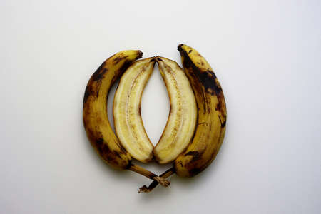 Overripe banana in a cut on a white background. Spoiled bananas.の写真素材