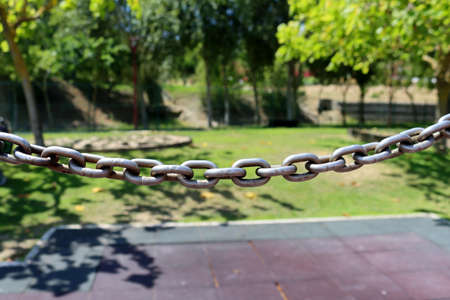 Metal chain on blur green nature - background conceptの写真素材