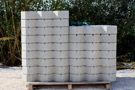 Concrete blocks for construction on wooden pallets are on the construction site.の写真素材