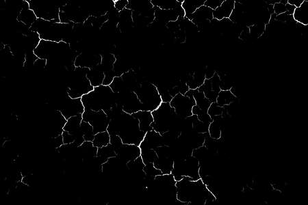 Grunge black and white pattern. Abstract texture of monochrome particles. Black background with white cracks, scuffs, chipsの写真素材