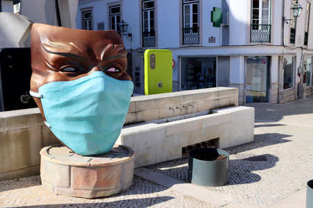 Torres Vedras, Portugal - February 2021: The famous Torres Vedras carnival. Covid-19 carnival theme. The carnival mask is wearing a medical mask.のeditorial素材