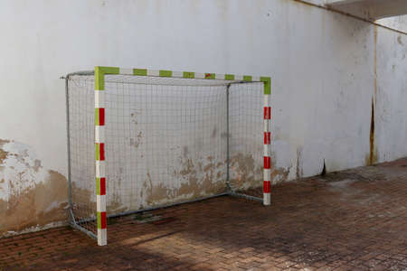 Old football goal against the background of a peeling wallの写真素材