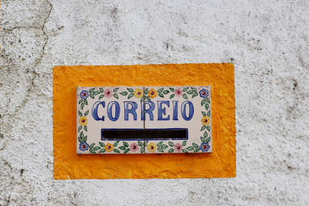 Characteristic Correio Box (in english: Mail Box) in a little village in Portugal. Old mailbox in the wall with painted tiles.の写真素材
