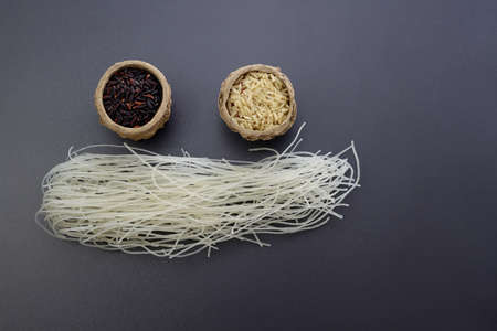 Black, white rice and rice noodles on a gray background. Asian cuisine.の写真素材