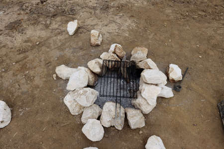 Outdoor grill. White stones, ash and grill grate.の写真素材