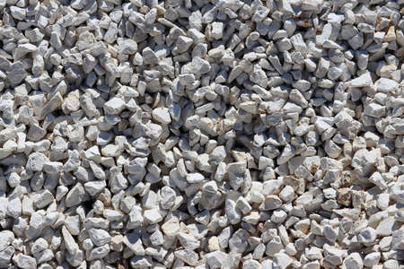 Small white and beige stones close-up. Stone texture and backgroundの写真素材