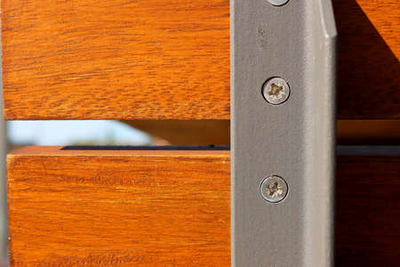 The metal base is attached with self-tapping screws to a wooden rail. Reliable and stable construction.の写真素材