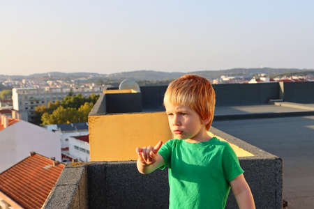 A blond boy with an indignant face. Emotional four year old boy.の写真素材