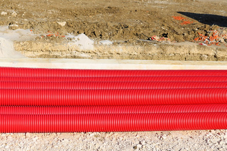 Plastic finned pipes on a construction site. Long red pipes.の写真素材