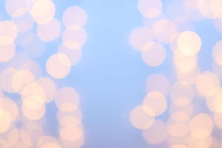 Bokeh on Christmas night. Natural bokeh outdoors in delicate yellow and lilac tones. Blurred background with Christmas illumination. Festive background for New Year Merry Christmas.の写真素材