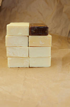 Light and dark bar of soap on a background of crumpled paper. The bars of soap were placed on top of each other.の写真素材