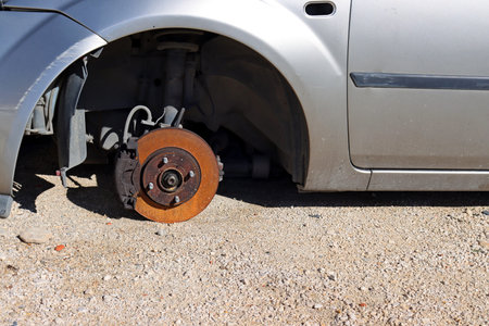 Rusty car wheel disc. Old car without wheels.