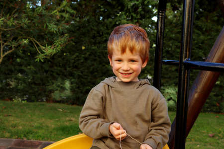 Smiling blond boy. Five year old boy with a big smileの写真素材