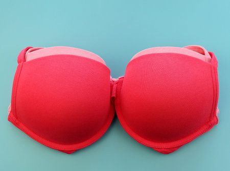 Pink cotton bras on a blue background. Women's underwear.の写真素材