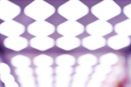 Abstract bokeh in lilac and white tones. Blurred background of ceiling lights.の写真素材