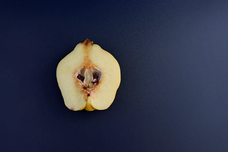 Fresh quince in section isolated on gray background . top view. flat layer