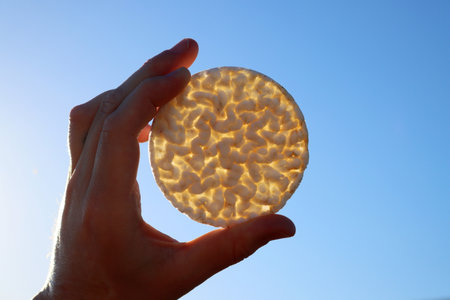Puffed rice cake shaped in the form of a circle through which sunlight shines through.の写真素材
