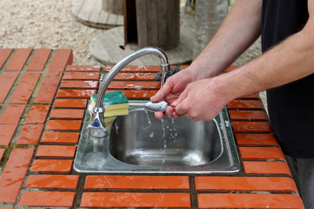 Close up hands washing spoon.の写真素材
