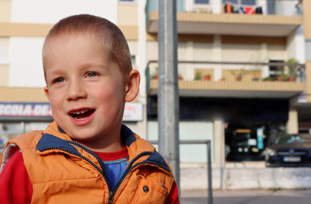 Portrait of a blond boy with an open mouth. Emotional six year old boyの写真素材