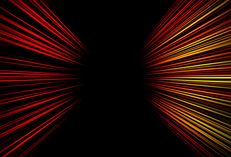 Abstract surface of radial zoom blur in red and yellow colors on a black background. Bright background with radial, diverging, convergent linesの写真素材
