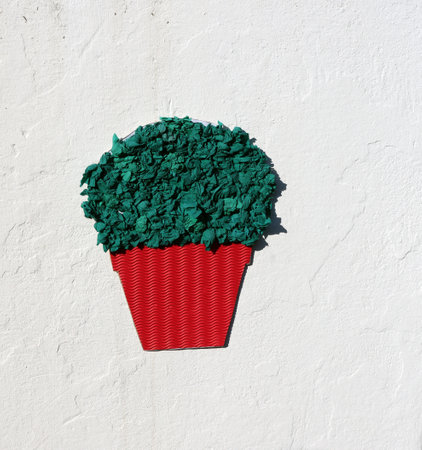 Red pot with green flowers made of paper. kids application.の写真素材