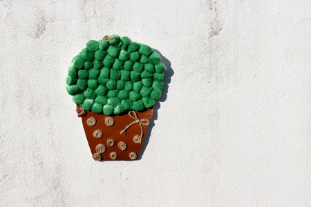 Brown pot with green flowers made of cotton and paper. children's application.の写真素材