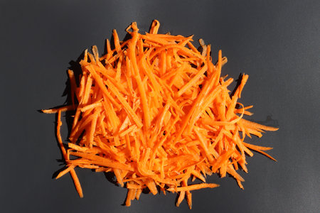 Grated carrots on a black background. Top view. Close-up.の写真素材