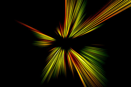 Abstract surface of radial zoom blur in orange, yellow, green tones on a black background. Spectacular background with radial, diverging, converging lines.の写真素材