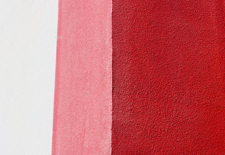 Minimalist textured wall with vertical white, pink, and dark red sections. Clean geometric...
