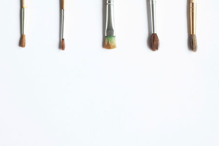 Different brushes for drawing on a white background top view copyspace