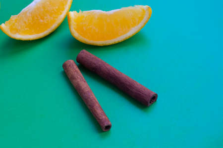 Orange and cinnamon on a green background flat layの写真素材