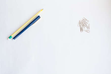 Pencil and pen and paper clips on a white background copy spaceの写真素材