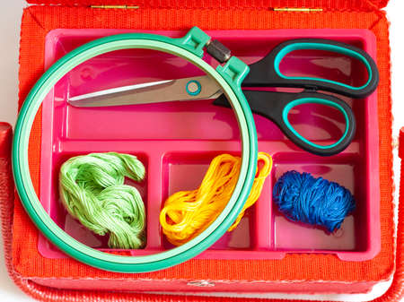 Creativity and needlework embroidery scissors thread and embroidery frame in a box top viewの写真素材
