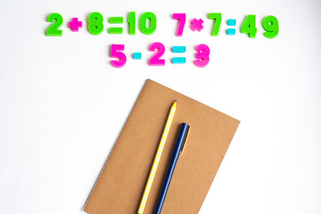 Math exercises notebook pen and pencil on a white background top view