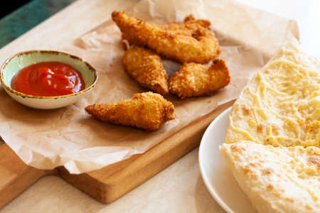 Lunch chicken nuggets tomato sauce and focacciaの写真素材