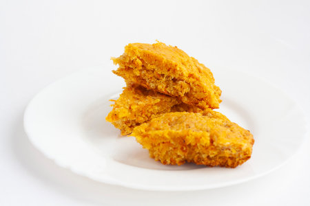 Vegan pastries carrot cake slices on a plate on a white background