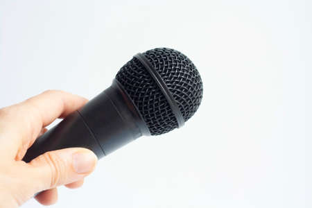 Microphone in hand on a white background, copy spaceの写真素材