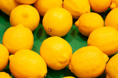 Background of yellow lemons in a box in the storeの写真素材