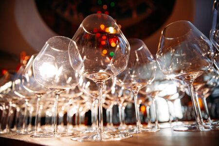 empty wine glasses photographed at a wide angle from a low point with a blurred backgroundの写真素材