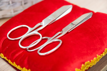 scissors on a red pillow for cutting the ribbon for the opening ceremony. ceremonial ribbon scissors at the opening ceremony on a red pillowの写真素材