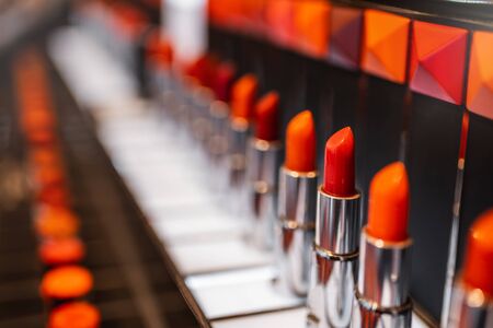 Red lipstick. a row of red lipstick in a metal case on the supermarket showcaseの写真素材